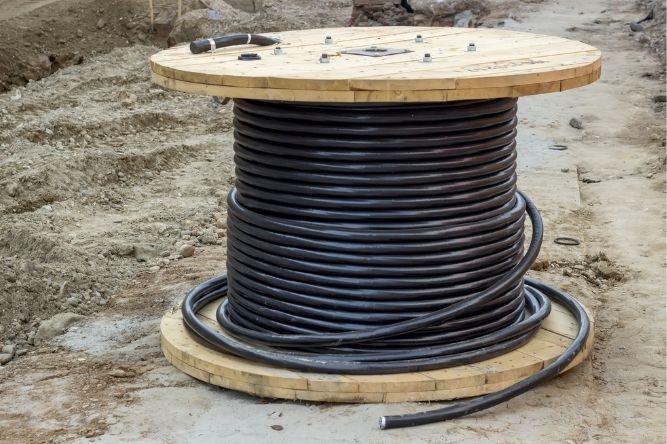 cable used for underground utilities is wrapped around a wooden post