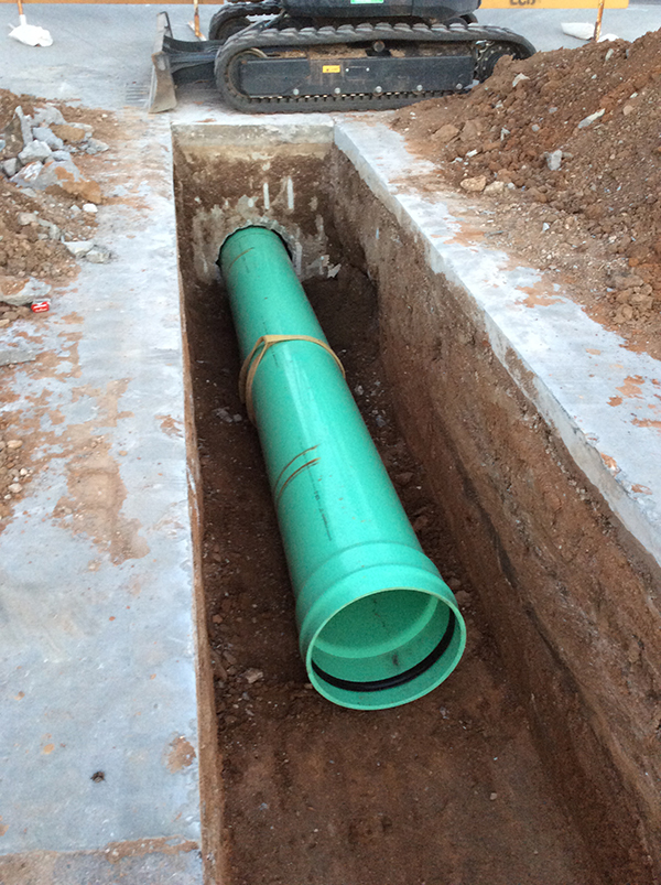 a green pipe inside the trench