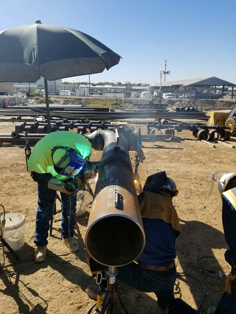 image of natural gas welding in process by two construction workers